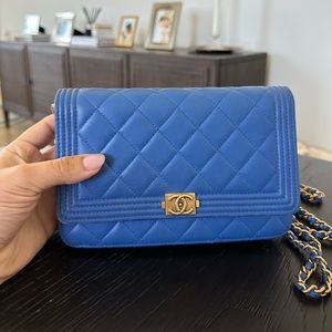 Chanel Boy Wallet on Chain in Blue lambskin with gold hardware.